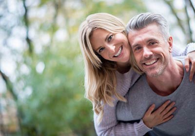 couple with dental implants smiling together