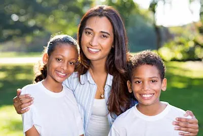family smiling together after dental cleaning in Spokane, WA