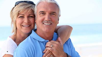 couple smiling after restorative dentistry procedure