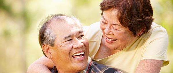 Happy couple smiling after dental implants