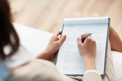 patient filling out dental insurance form